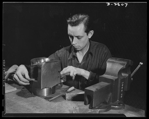 Conversion. Safe and lock company. Ex-auto mechanic pictured at work in ex-lock factory. Merril Darr, twenty-five, works on breech ring for a thirty-seven-millimeter gun. These guns and thirty-seven-millimeter gun mounts are now produced in a plant which formerly manufactured items for civilian use.
