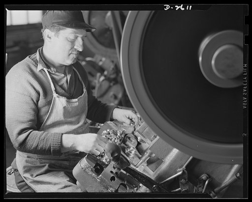 Conversion. Toy factory. This worker formerly produced toy wheels on this press; now his converted press adds to Uncle Sam's might in production of condenser caps for the Signal Corps, and of radio filter boxes for jeeps and tanks. Keystone