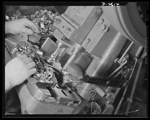 Conversion. Toy factory. Closeup of press in production of condenser caps to which it has been converted. Former production of this machine consisted of toys and movie projectors. Keystone
