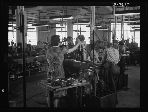 Conversion. Safety razor plant. In a New England plant manufacturing safety razors, honed head blade clips for razors. Normally her full-time job, Estelle now spends much of her time grinding V-blocks on these same machines, which are rapidly being converted to war production work under a subcontrac