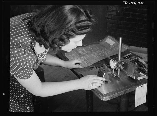 Conversion. Safety razor plant. Estelle Wilson, one of a New England razor factory's many women workers, checks completed V-blocks with blueprint specification. Because of their previous training, reading blueprints is no novelty to women employed in this plant which is now producing tool posts unde