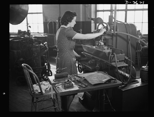 Conversion. Safety razor plant. From razor blades to V-blocks in few weeks! That's the story of Estelle Wilson, one of a New England razor company's many women employees who are now operating machines recently converted to production of war essentials. Gillette