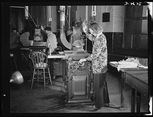 Conversion. Safety razor plant. Operation of surface grinder in production of V-blocks for the machine that makes America's war machine. Women are rapidly being drafted to fill men's jobs on light-duty machines as this