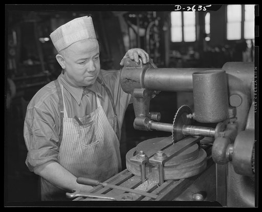 Conversion. Food machinery plant. Operator of this universal milling machine is John J. Morris, shown here cutting steel disk covers for his company's normal product--cube steak machines. Today Morris uses the same machine adapted to war subcontract work --cutting of large hexagonal nuts for a gover
