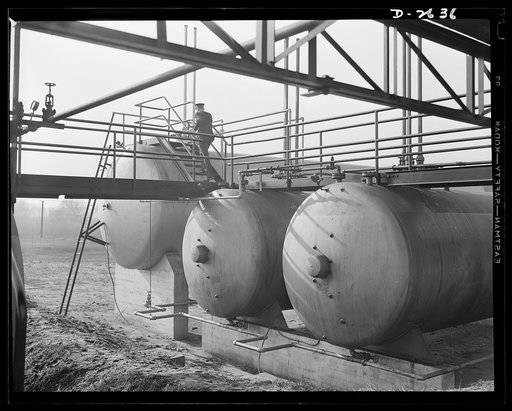 Synthetic rubber (Ameripol). These tanks contain vegetable fats and butadiene, a highly volatile gas "cracked" from crude petroleum. These raw materials for synthetic rubber are piped from freight cars into these storage tanks. Goodrich