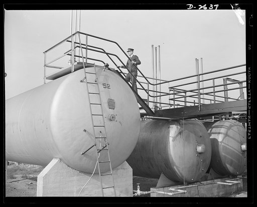 Synthetic rubber (Ameripol). These tanks contain vegetable fats and butadiene, a highly volatile gas "cracked" from crude petroleum. These raw materials for synthetic rubber are piped from freight cars into these storage tanks. Goodrich