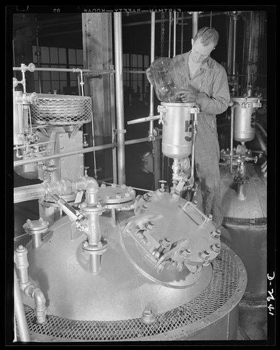 Synthetic rubber (Ameripol). This worker at the Akron, Ohio, synthetic rubber plant of the B.F. Goodrich Company, is adding a catalyst to a polymerizer tank, to speed up the process of changing various raw materials into latex. Goodrich