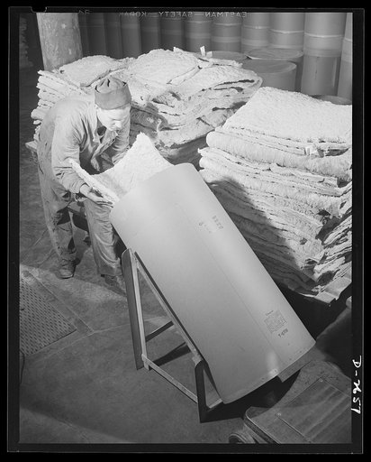 Synthetic rubber (Ameripol). Now thoroughly dried, these sheets of synthetic rubber are packed in larger paper drums, each holding 200 pounds for shipment. Goodrich