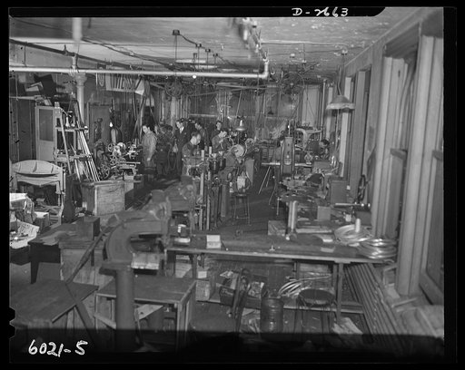 Conversion. Frying pans to aircraft parts. Using a lathe converted from manufacture of egg poachers, frying pans and radio parts, this employee of a small Eastern plant is polishing a die which will make parts to be used on American fighting plane. Precision Metal Company, New York, New York
