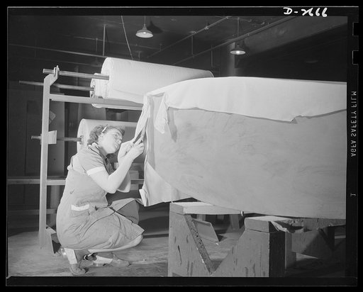 Self-sealing fuel tanks. The heavy paper building forms for bullet-sealing fuel tanks must be covered with cloth. Women are doing a large portion of the work in turning out these tanks. Goodrich