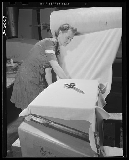 Self-sealing fuel tanks. The heavy paper building forms for bullet-sealing tanks must be covered with cloth. Women are doing a large portion of the work in turning out these tanks. Goodrich