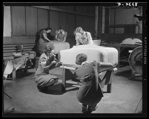 Self-sealing fuel tanks. The heavy paper building forms for bullet-sealing tanks must be covered with cloth. Women are doing a large portion of the work in turning out these tanks. Goodrich
