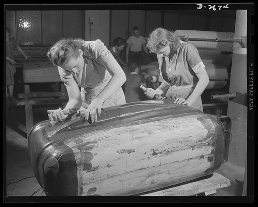Self-sealing fuel tanks. Not only as nurses behind the battle lines, but as workers in the factory producing important war goods, women are doing much to win this war and to spare the lives of the men doing the actual fighting. These girls are fitting inner ply to a building form, a safety developme