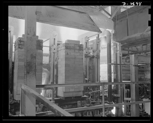 Fiberglass manufacture, Owens-Corning, Toledo, Ohio. Side view of a glass furnace melting the carefully compounded batch required for the production of fiberglass thermal insulation being installed in the hulls of naval vessels now under construction