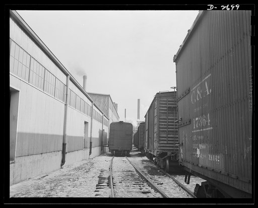 Fiberglass manufacture, Owens-Corning, Toledo, Ohio. At the loading dock in a Midwest warehouse, some seventy-five percent carloads of fiberglass materials are shipped daily to supply shipyards, electrical manufacturers, and other war industries
