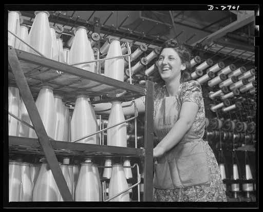 Fiberglass manufacture, Owens-Corning, Toledo, Ohio. Not bottles of milk, but bobbins of glass yarn. From the twisting frames where glass fiber is converted into fiberglass yarns of standard construction, the worker takes the all-glass material to the weaving department for fabrication into tapes an