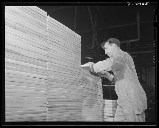 Fiberglass manufacture, Owens-Corning, Toledo, Ohio. Ready for cartons and bound for a shipyard are these neatly stacked boards of fiberglass insulation, surfaced with a fireproof all-glass cloth. The material is used to replace aluminum sheathing for interior finish in naval vessels. Installation m
