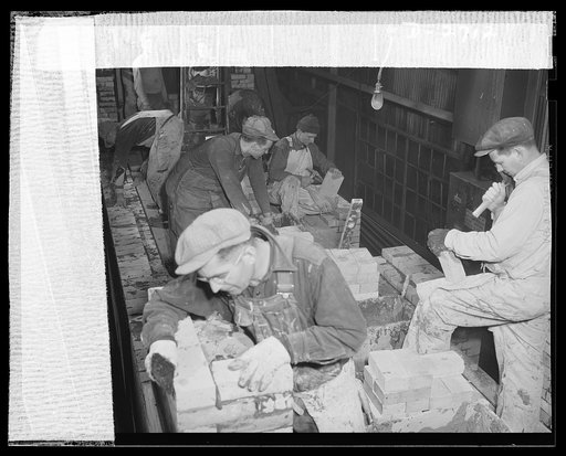 Fiberglass manufacture, Owens-Corning, Toledo, Ohio. To increase productive capacity and meet war demands for fiberglass thermal and acoustical insulation, workmen in a plant of the Owens-Corning Fiberglass Corporation are laying firebrick. This is the first step in the construction of one of the hu