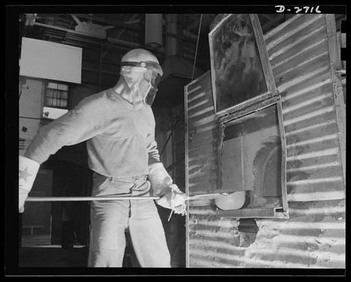 Fiberglass manufacture, Owens-Corning, Toledo, Ohio. This worker is ladling white-hot molten glass from a furnace in a plant of Owens-Corning Fiberglass Corporation. When viscosity of the molten glass is at the point required by rigid quality control specification, it will be used to form the glass 