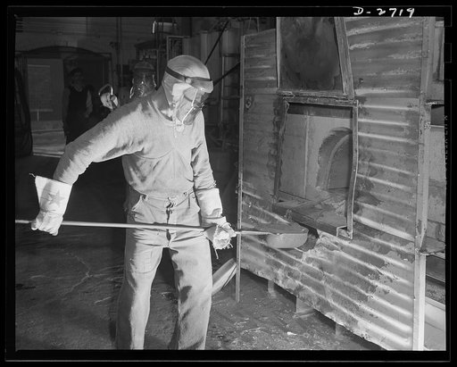 Fiberglass manufacture, Owens-Corning, Toledo, Ohio. This worker is ladling white-hot molten glass from a furnace in a plant of the Owens-Corning Fiberglass Corporation. When viscosity of the molten glass is at the point required by rigid quality control specifications, it will be used to form glass