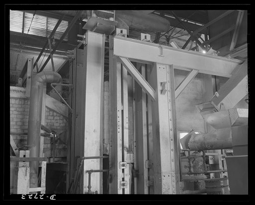Fiberglass manufacture, Owens-Corning, Toledo, Ohio. Side view of a glass furnace melting the carefully compounded batch required for the production of fiberglass thermal insulation being installed in the hulls of naval vessels now under construction
