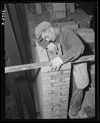 Fiberglass manufacture, Owens-Corning, Toledo, Ohio. To increase productive capacity and meet war demands for fiberglass thermal and acoustical insulation, workmen in a plant of the Owens-Corning Fiberglass Corporation are laying firebrick. This is the first step in the construction of one of the hu