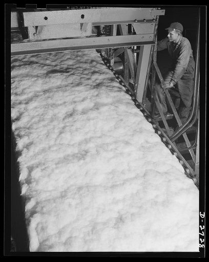 Fiberglass manufacture, Owens-Corning, Toledo, Ohio. In a resilient, lightweight blanket of interlaced fibers, fiberglass thermal insulation is carried along from the furnaces where it is produced to be packaged or further fabricated into the forms required by Army and Navy specifications