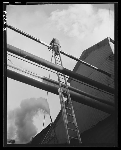Fiberglass manufacture, Owens-Corning, Toledo, Ohio. Like the chef who eats his own cooking, Owens-Corning Fiberglass Corporation uses its own fiberglass pipe covering. Here a maintenance man at one of the plants applies weatherproof paint to a section of high pressure steam piping. More than 200 mi