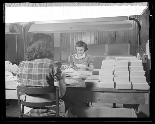 Fiberglass manufacture, Owens-Corning, Toledo, Ohio. Wafer-thin sheets of bonded glass fiber are cut to size, inspected and packaged by workers like these in a plant of Owens-Corning Fiberglass Corporation. They are retainer mats being supplied under Army and Navy specifications for storage batterie