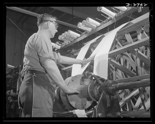 Fiberglass manufacture, Owens-Corning, Toledo, Ohio. Warp yarns of fiberglass are being paralleled on a beam preparatory to weaving all-glass fabrics