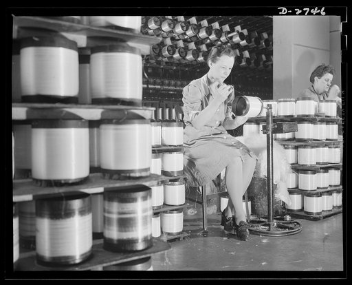 Fiberglass manufacture, Owens-Corning, Toledo, Ohio. Workers in a plant of the Owens-Corning Fiberglass Corporation prepare strands of glass fiber for twisting into all-glass yarns
