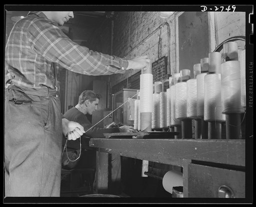 Fiberglass manufacture, Owens-Corning, Toledo, Ohio. A quality control inspector in a plant of the Owens-Corning Fiberglass Corporation checks the weight of staple glass fiber to insure conformity with rigid specifications