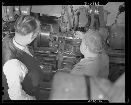 Conversion. Soft drink dispenser plant. Converted from the production of such items as soft drink dispensers and game boards, this Eastern manufacturing firm now produces precision tools for cartridge manufacture, brass quadrants and other essentials for the armed forces. Here workmen are inspecting