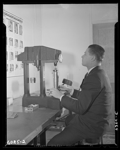 Conversion. Soft drink dispenser plant. The vice-president of an Eastern manufacturing company now producing war essentials on prime and subcontracts, tests the hardness of steel in a chamber gauge, essential for the manufacture of small arms ammunition. These gauges are made of special alloys tough