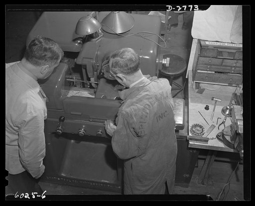 Conversion. Soft drink dispenser plant. High speed grinding of a bullet punch goes on twenty-two hours a day in an Eastern manufacturing company converted from the manufacture of civilian items to one hundred percent production for war. Bristol and Martin Company, New York, New York