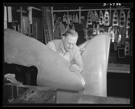 Conversion. Auto body plant. Workman inspects the tail section of an airplane in a Midwest automobile body plant now converted to production of war essentials. Briggs Manufacturing Company, Detroit, Michigan