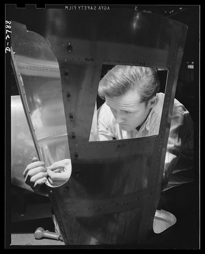 Conversion. Auto body plant. He used to be an automobile worker, but he's one of Uncle Sam's war workers these days, with the conversion of his company to the production of airplane parts. In the picture above he's driving rivets in an airplane tail section. Briggs Manufacturing Company, Detroit, Mi