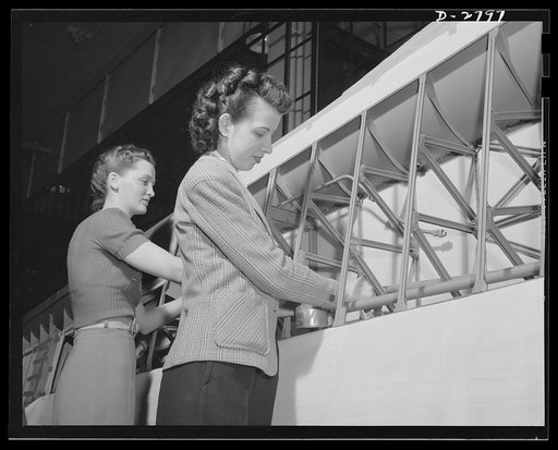 Conversion. Auto body plant. A job often delegated to women in aircraft manufacture is touching up metal braces on ailerons with paint before wing structure is completed. This picture was taken in one of America's automobile body plants newly converted to airplane production. Briggs Manufacturing Co
