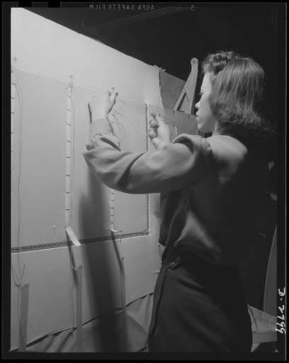 Conversion. Auto body plant. A job often delegated to women in aircraft manufacture is touching up metal braces on ailerons with paint before wing structure is completed. This picture was taken in one of America's automobile body plants newly converted to airplane production. Briggs Manufacturing Co