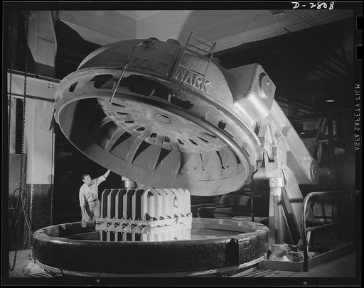 Conversion. Tire plant. This vulcanizing unit, largest in the world, was designed for the vulcanizing of giant tires used on earth-moving machinery, but is now helping out the war program by vulcanizing self-sealing gas tanks for the nation's war planes. The mold containing the tank has been lowered