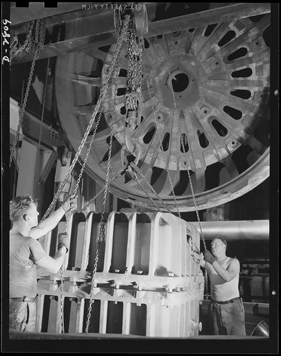 Conversion. Tire plant. This vulcanizing unit, largest in the world, was designed for the vulcanizing of giant tires used on earth-moving machinery, but is now helping out the war program by vulcanizing self-sealing gas tanks for the nation's war planes. The special mold containing the tank is being