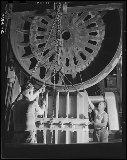 Conversion. Tire plant. This vulcanizing unit, largest in the world, was designed for the vulcanizing of giant tires used on earth-moving machinery; is now helping out the war program by vulcanizing self-sealing gas tanks for the nation's war planes. The mold containing the tank has been lowered int