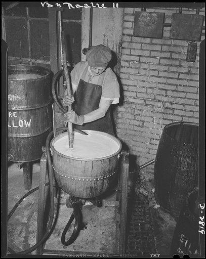 Conversion. Hosiery factory. Permalon solution, a chemical mixture used on mosquito netting is mixed by a worker in a large Eastern mill which formerly made women's stockings. This chemical solution stiffens the netting and prevents subsequent shrinkage, so that the hardest tropical downpour which A