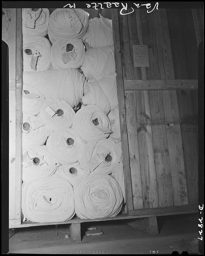 Conversion. Hosiery factory. Bales of mosquito netting lie ready to be packed in crates for shipment to ordnance officers throughout the country. Women's hosiery was once the chief product of this Eastern mill which is now forty-percent converted to the production of netting for American troops. Van