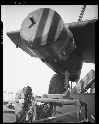 Lease lend loadings. Welding wheels of Douglas twin-engine light bombers to a platform on deck insures safe transit from an American port to the bombers' destination. Crews of highly specialized workers are required to load assembled planes on shipboard and to prevent their becoming dislodged in hea