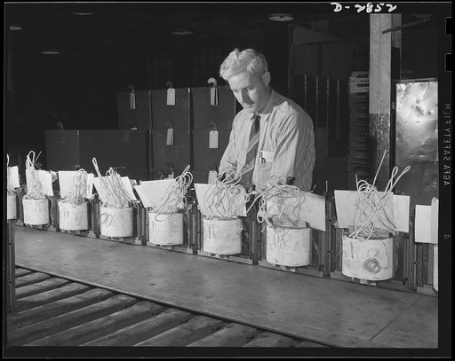 Transformer manufacture. Essential to the efficiency of thousands of plants producing war materials are these distribution transformers, here being assembled on assembly line in a large Eastern plant. Westinghouse, Sharon, Pennsylvania
