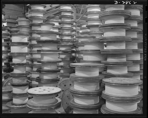 Transformer manufacture. Forming the heart of the giant transformers which manufacture power for America's war production plants, these spools of copper wire are lifted by a crane, guided into place by a worker. Westinghouse, Sharon, Pennsylvania