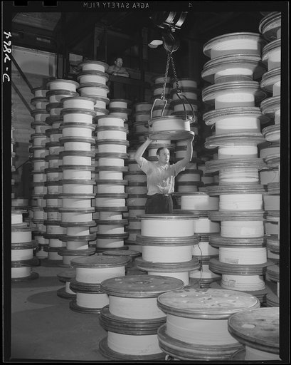Transformer manufacture. Forming the heart of the giant transformers which manufacture power for America's war production plants, these spools of copper wire are lifted by a crane, guided into place by a worker. Westinghouse, Sharon, Pennsylvania