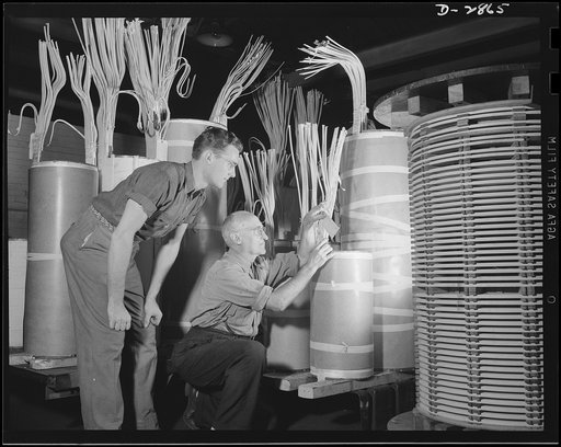 Transformer manufacture. Granddaddy to 57, Henry Bert (right) has been with a large Eastern electrical plant for almost half a century. Now he's as important to the war as though he were on the front line, for he's one of the many workers who manufacture transformers, essential to defense. He's show