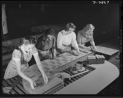 Transformer manufacture. Preparation of insulating board used between copper coils on distribution transformers is done by women employees of a large Eastern electrical company. These young women are extremely valuable to Uncle Sam, because the product they are making is used in almost every phase o